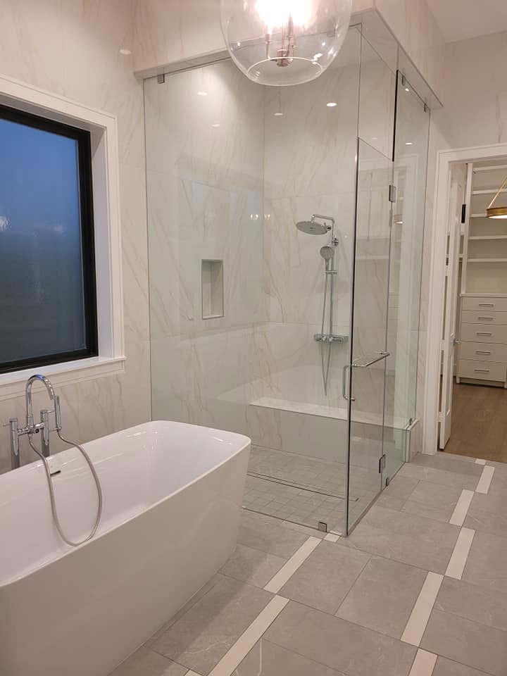Modern luxury bathroom with freestanding tub and frameless glass shower enclosure