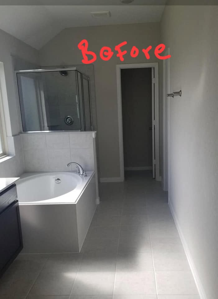 Before photo of empty bathroom with white tiles, bathtub, and shower enclosure